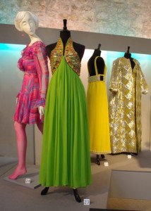 Left to right: pink silk chiffon print dress, unlabelled, spring 1968; sequined green silk dress by Oscar de la Renta for Jane Derby, c. 1968; Yellow silk backless dress by Heinz Riva, Rome, c. 1966; gold and silver lame evening gown and coat by Richard Tam for Sara Fredericks, spring 1968.
